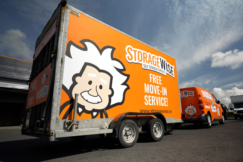 van and trailer driving away from a self storage centre