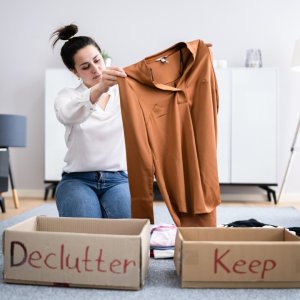 Woman organising clothes into declutter or keep